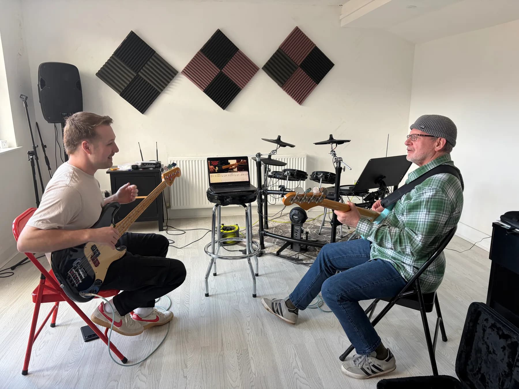 A bass teacher and student working together