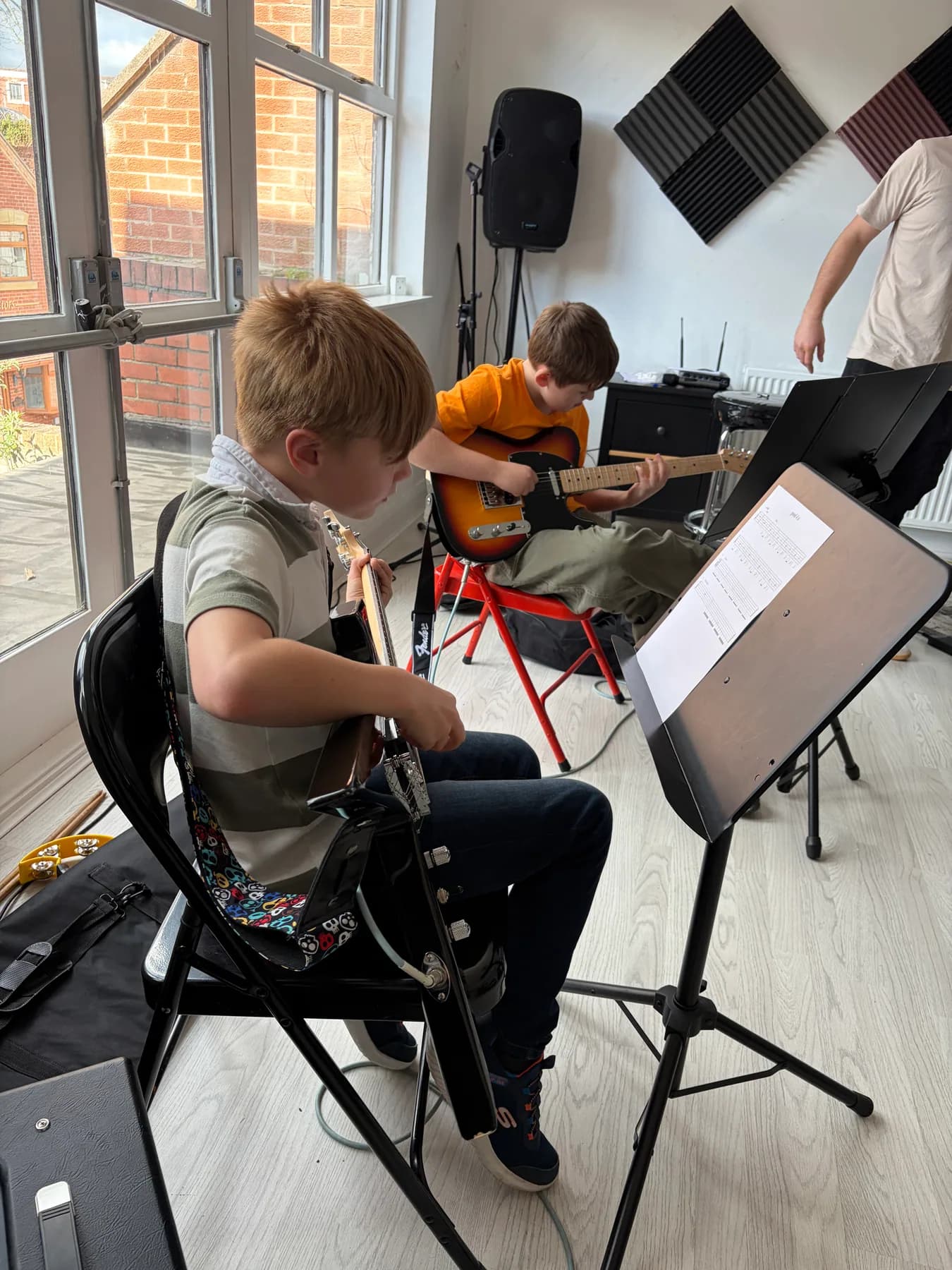 Two young guitar students playing together