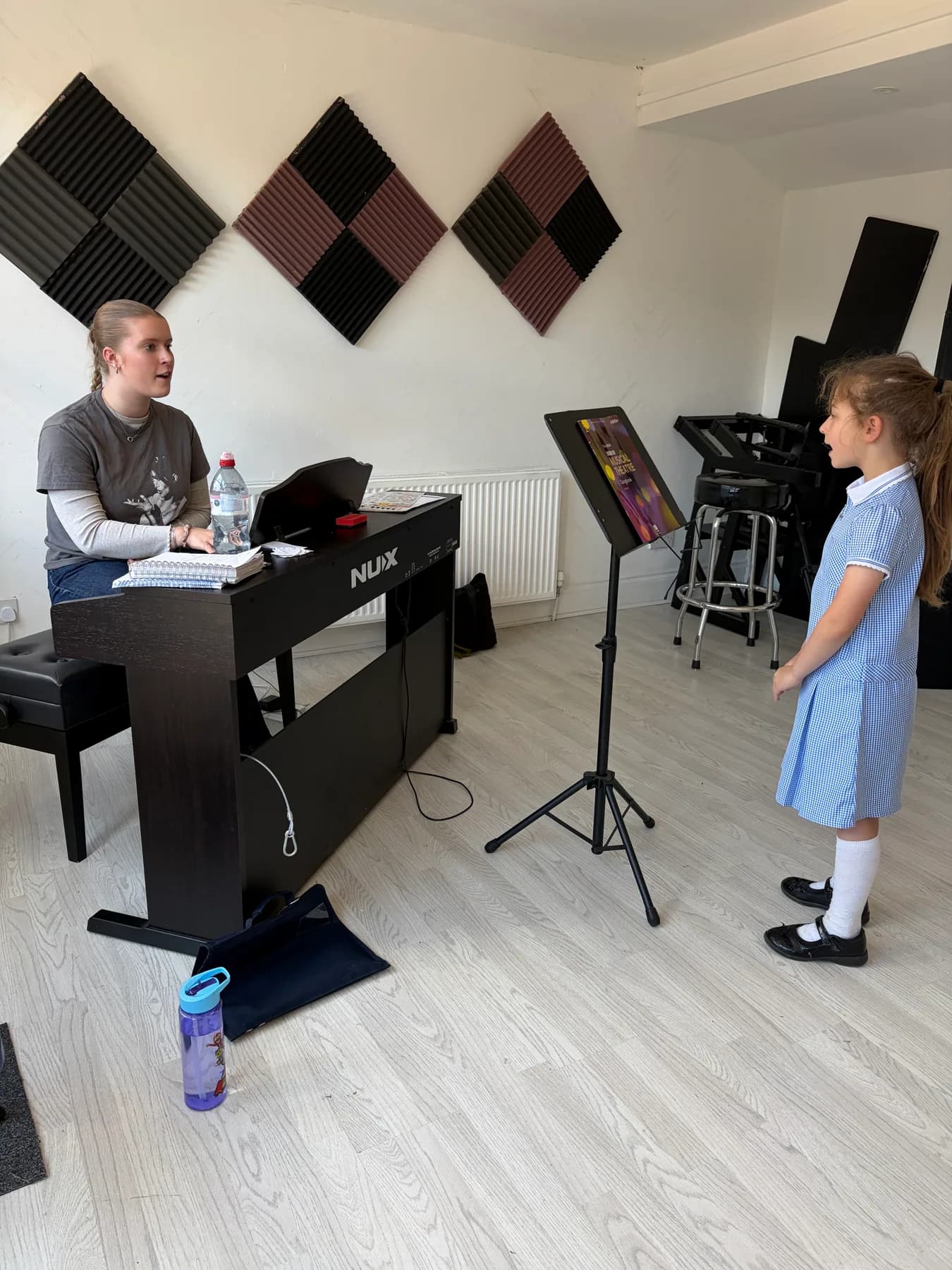 A young singer enjoying a vocal lesson at Apollo Music School